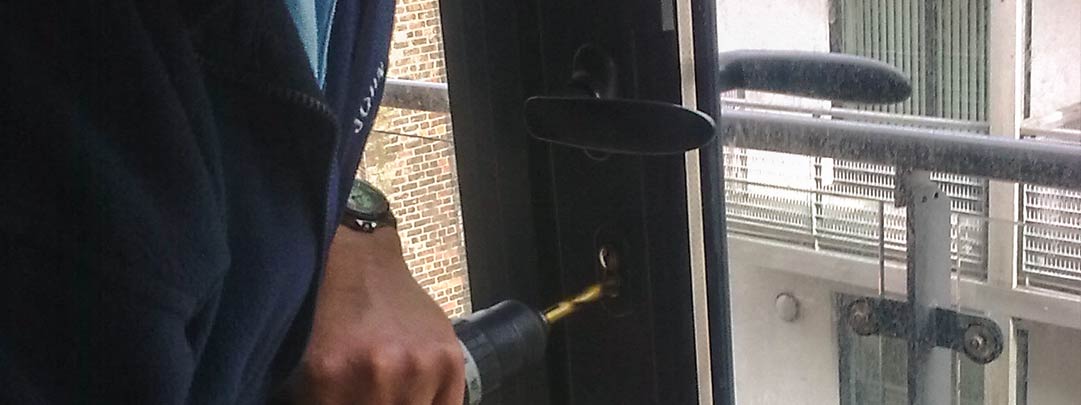 One of our lock specialists fixing a broken barrel on an aluminium door, Liverpool City Center.